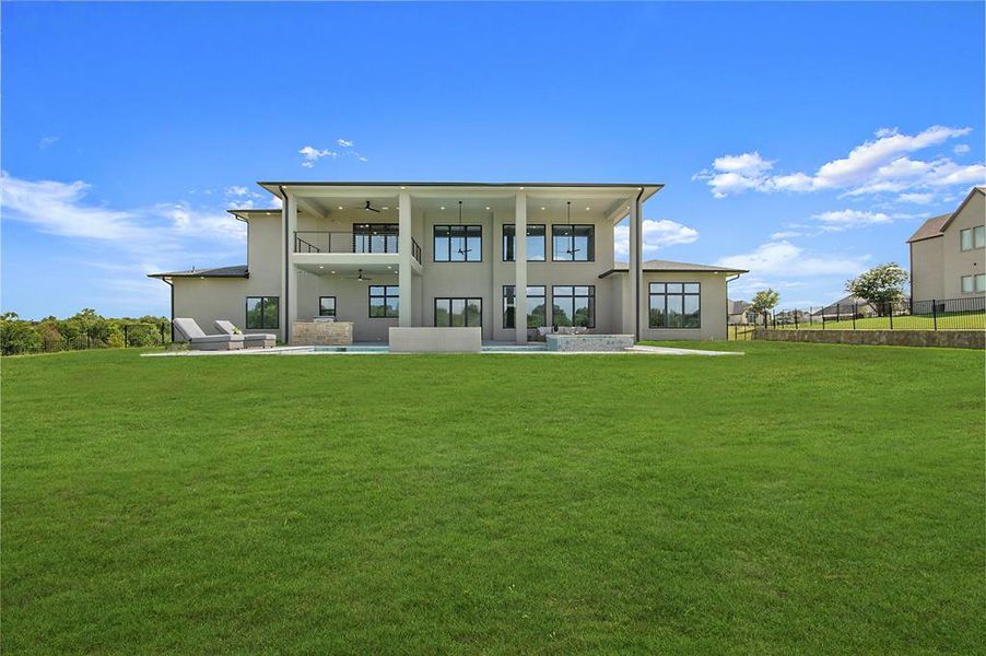 Back of property featuring ceiling fan, stucco siding, and a patio area