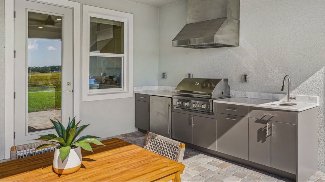 Oleander Rear Lanai with a Summer Kitchen by DRB Homes in Ardisia Park in New Smyrna Beach, FL