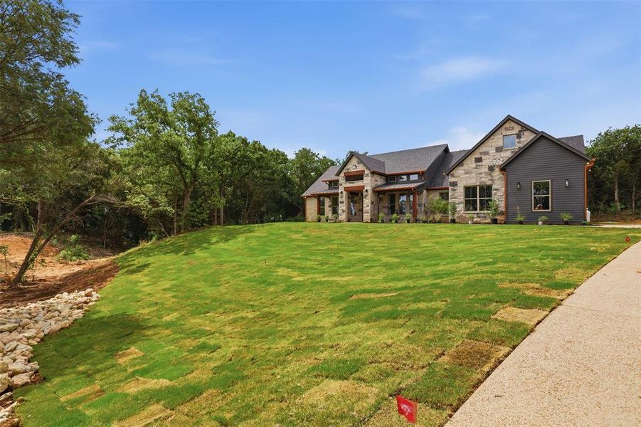 Front exterior of a new home in , Granbury, TX, highlighting curb appeal (Image 2). Front exterior of a new home in , Granbury, TX, highlighting curb appeal (Image 2).