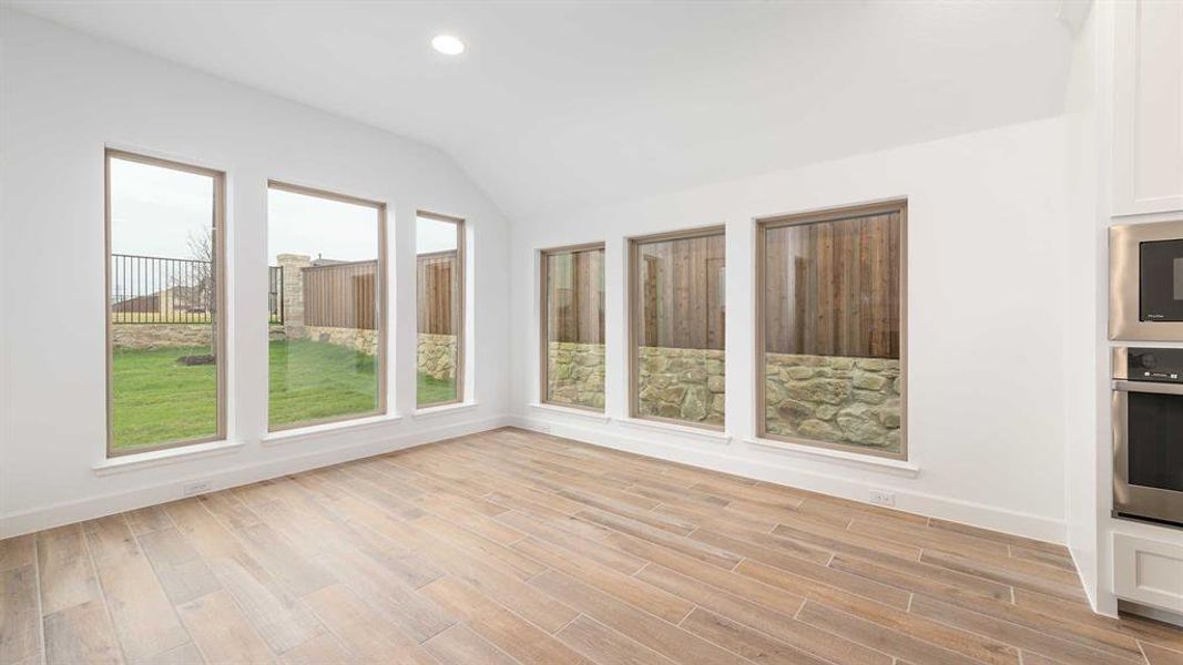 Unfurnished sunroom featuring lofted ceiling