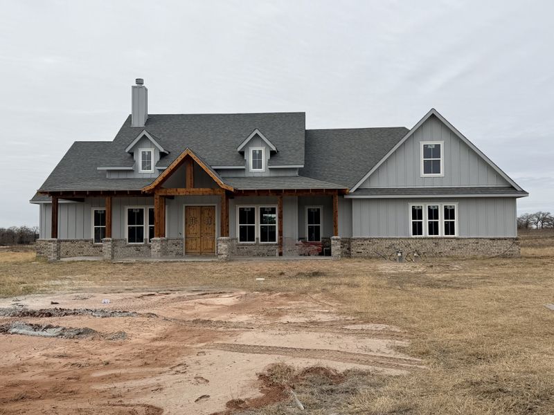 Front exterior of a new home in Oak Water Ranch, Granbury, TX, highlighting curb appeal (Image 6).