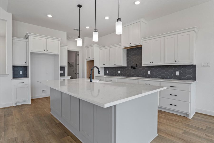 Kitchen and living area view emphasizing open-concept design.