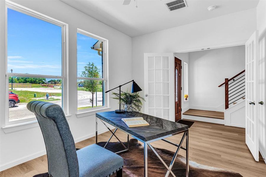 Office space featuring light hardwood / wood-style floors, french doors, and ceiling fan