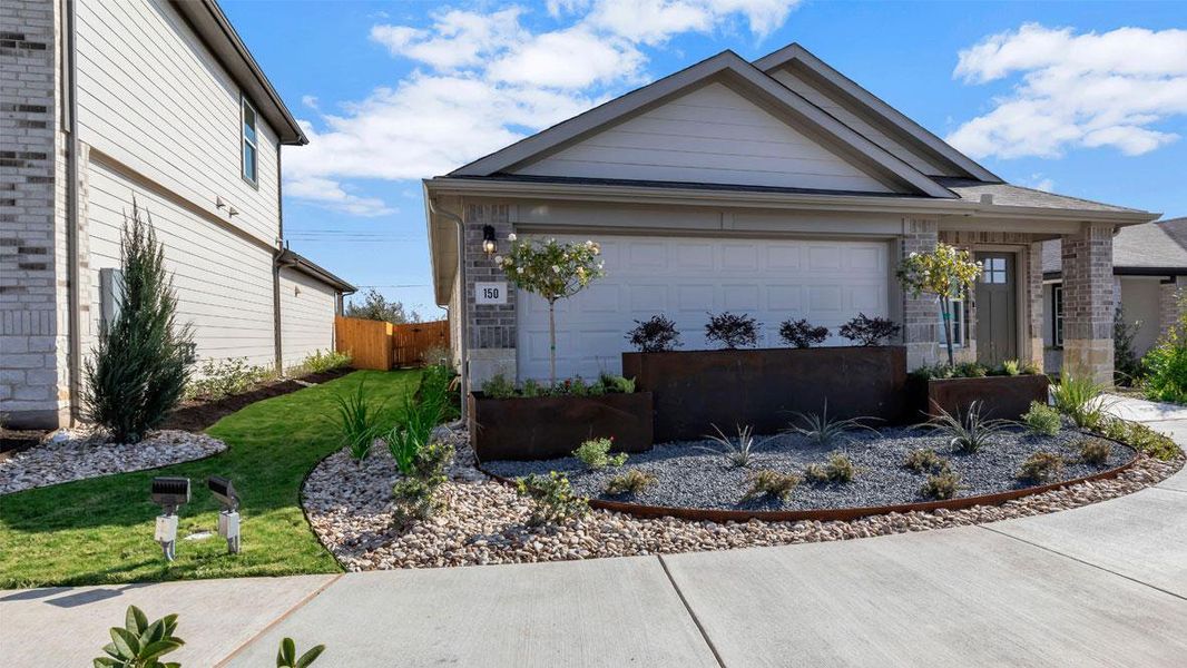 Front exterior of a new home in Prairie Lakes, Buda, TX, highlighting curb appeal (Image 20).
