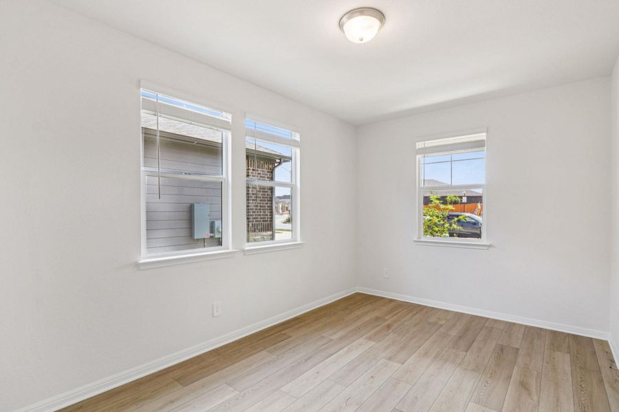 Unfurnished room featuring baseboards and light wood-style flooring Unfurnished room featuring baseboards and light wood-style flooring