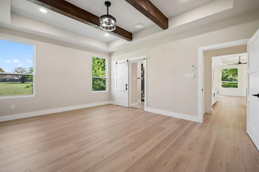 Primary Bedroom with  bath, recessed lighting, light wood-style floors, a ceiling fan, and beamed ceiling