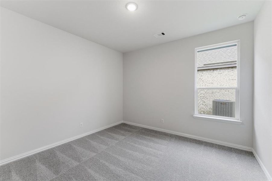 Carpeted room featuring a single window with white trim, a recessed ceiling light, and light-toned wall finishes