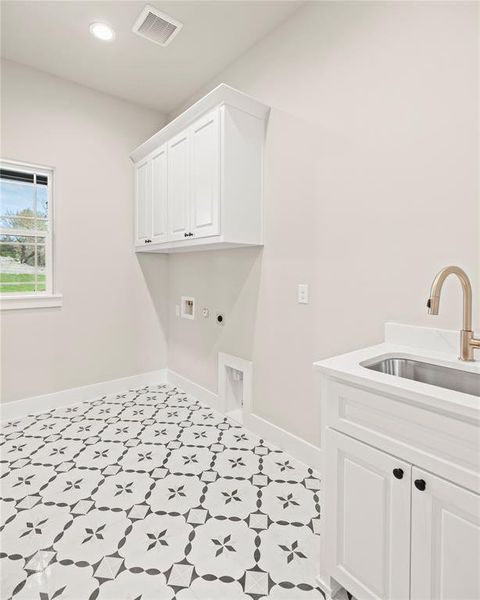 Washroom with cabinet space, hookup for a gas dryer, recessed lighting, hookup for a washing machine, and hookup for an electric dryer Washroom with cabinet space, hookup for a gas dryer, recessed lighting, hookup for a washing machine, and hookup for an electric dryer