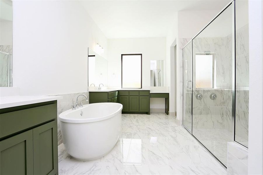 Bathroom with a marble finish shower, plenty of natural light, a soaking tub, and marble finish floor