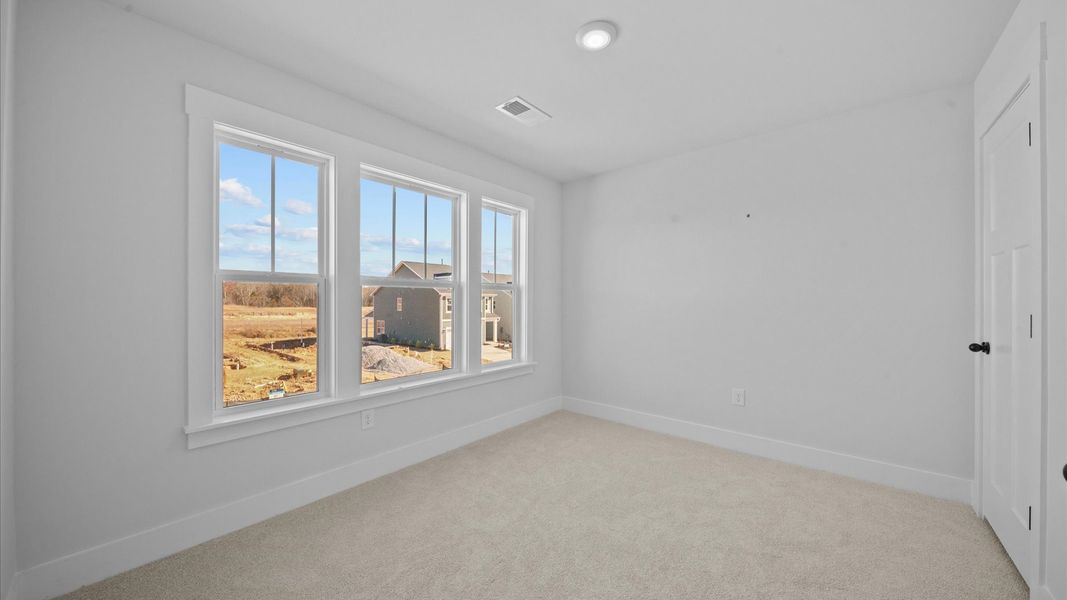 First-class bedroom with generous proportions, a walk-in closet, and beautiful natural light through large windows