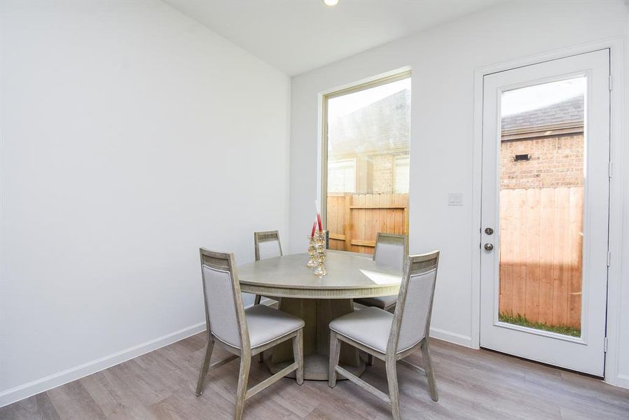 Wall and patio door windows bring natural light into this spacious breakfast nook.