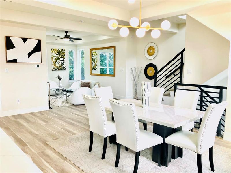 Seamlessly blending sophistication with comfort, this open-concept space merges a chic dining area with a welcoming living room—ideal for both lively gatherings and tranquil downtime.