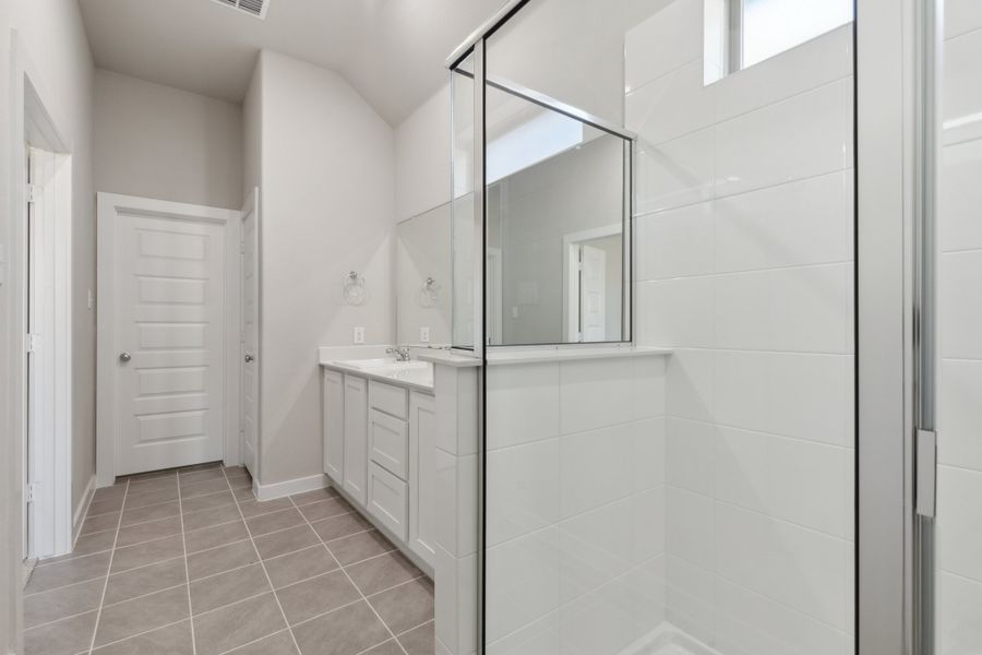 Primary Bathroom in the Claret home plan by Trophy Signature Homes – REPRESENTATIVE PHOTO