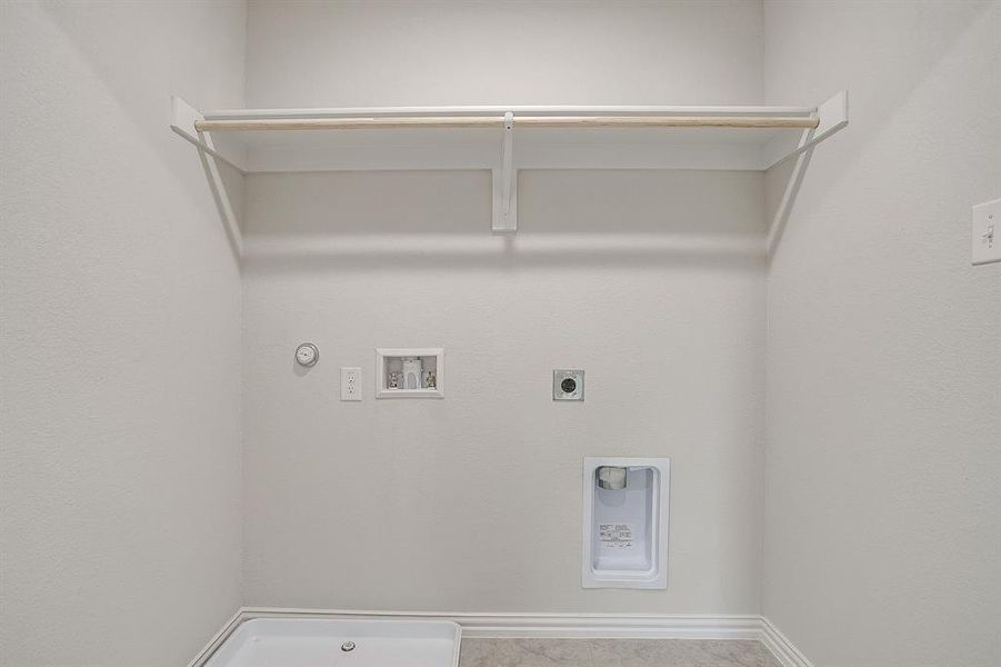 Washroom with hookup for a gas dryer, hookup for a washing machine, and hookup for an electric dryer