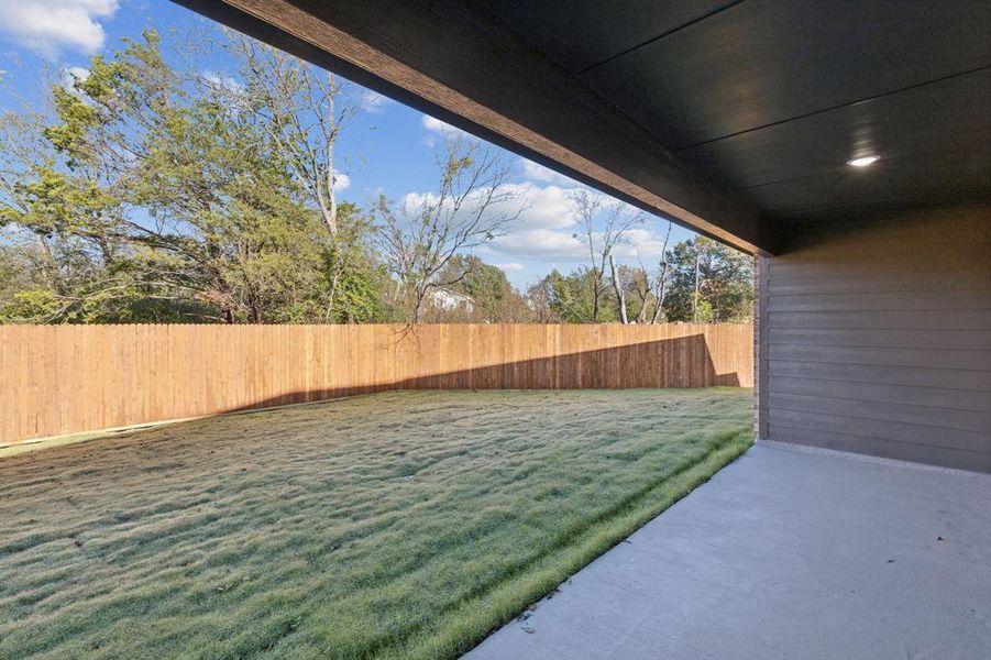 Fenced backyard featuring a patio