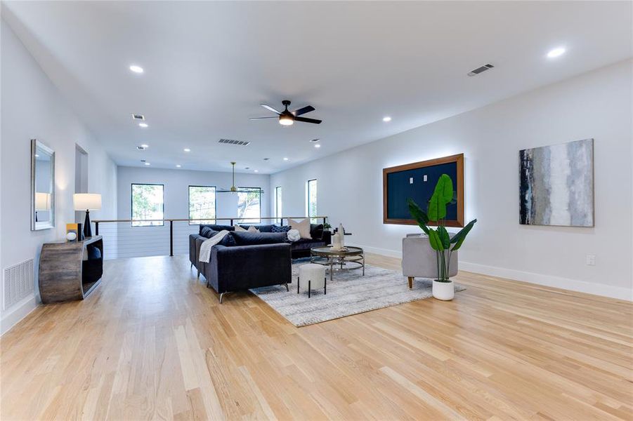 Living room with light wood-type flooring and ceiling fan