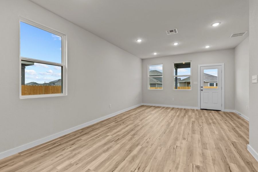A room with a wood floor and a window with a view of the ocean. A room with a wood floor and a window with a view of the ocean.