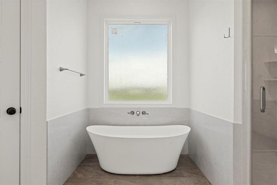 Bathroom with a freestanding tub and an enclosed shower Bathroom with a freestanding tub and an enclosed shower