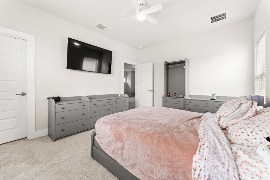 The third bedroom features a walk-in closet, ceiling fan with light fixture, and a TV mount.