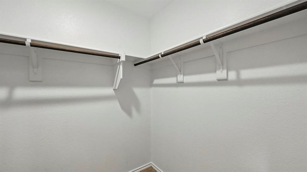 The property features a walk-in closet with ample hanging space and white walls