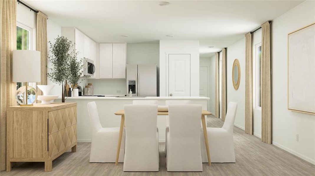 Kitchen with refrigerator with ice dispenser, a breakfast bar, light hardwood / wood-style floors, and white cabinetry