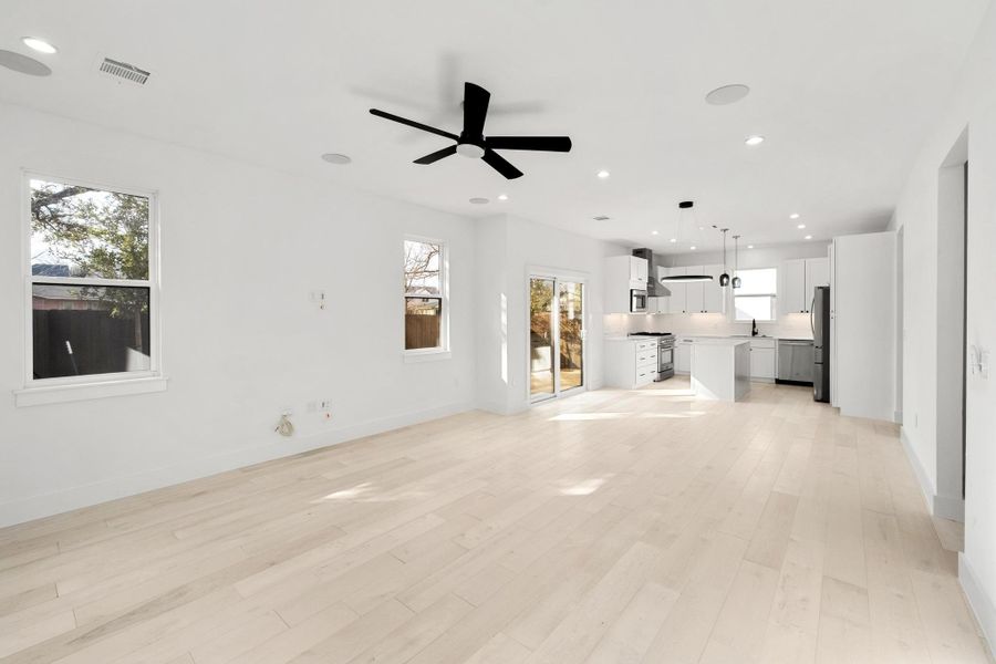 Unfurnished living room featuring ceiling fan, recessed lighting, and light wood-style flooring