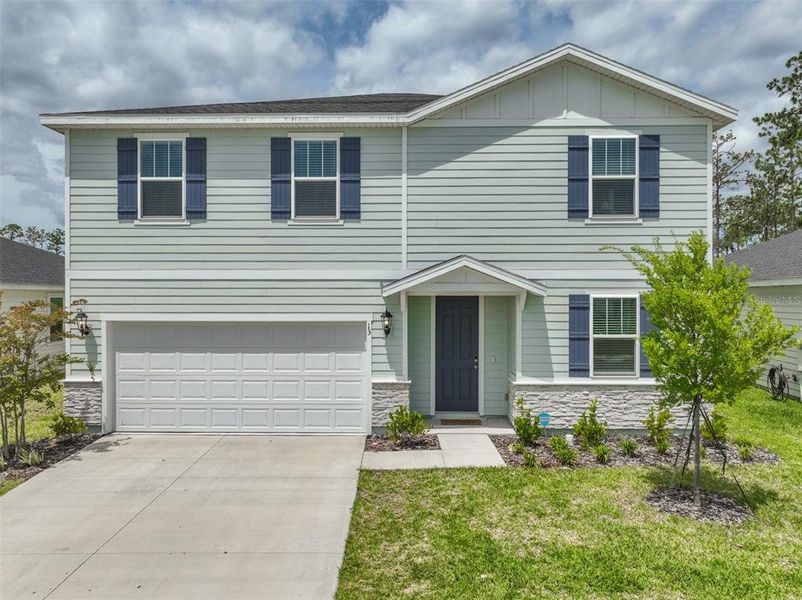 Front exterior of a new home in , Palm Coast, FL, highlighting curb appeal (Image 1). Front exterior of a new home in , Palm Coast, FL, highlighting curb appeal (Image 1).