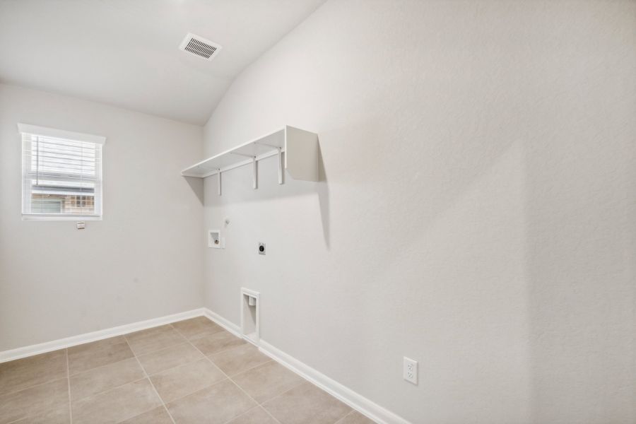 Laundry room in the Fitzhugh floorplan in a Meritage Homes community.