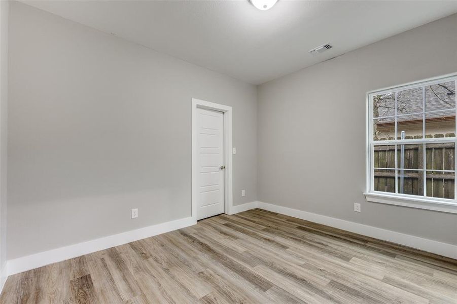 Empty room with light wood finished floors and baseboards