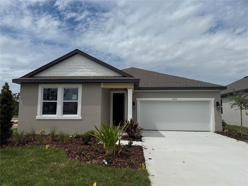 Front exterior of a new home in Oakfield Trails Traditional, Parrish, FL, highlighting curb appeal (Image 1).