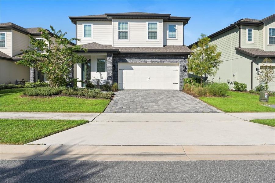 Front exterior of a new home in Reunion Village, Kissimmee, FL, highlighting curb appeal (Image 27).