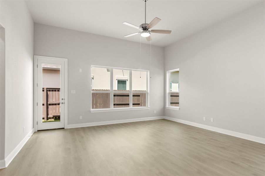 Spare room with wood finished floors and ceiling fan Spare room with wood finished floors and ceiling fan