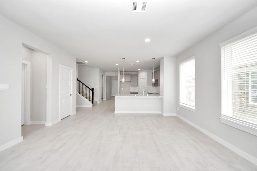 Family room flooded with natural light through the expansive windows. The premium tile flooring adds a touch of luxury to the space, creating the perfect setting for relaxing moments and cherished gatherings with loved ones. Sample photo of completed home with similar floor plan. Actual colors and selections may vary. Family room flooded with natural light through the expansive windows. The premium tile flooring adds a touch of luxury to the space, creating the perfect setting for relaxing moments and cherished gatherings with loved ones. Sample photo of completed home with similar floor plan. Actual colors and selections may vary.