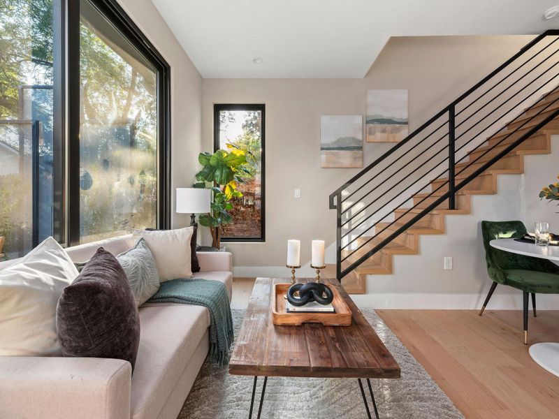 Living room with wood finished floors and stairway Living room with wood finished floors and stairway