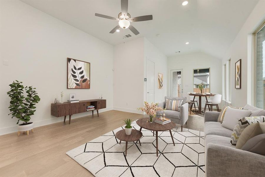 Living room featuring vaulted ceiling, light wood-type flooring, recessed lighting, and ceiling fan