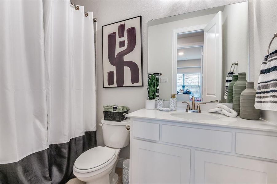 Bathroom with vanity and curtained shower