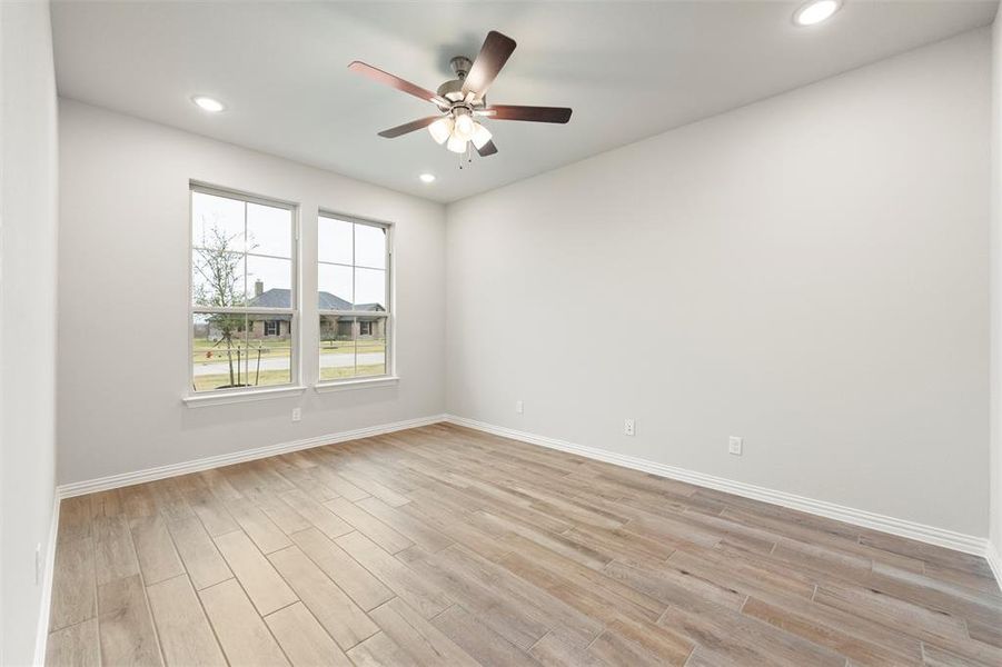 Spare room with light wood-type flooring, recessed lighting, and a ceiling fan Spare room with light wood-type flooring, recessed lighting, and a ceiling fan