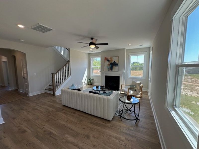 This inviting living area boasts rich hardwood flo