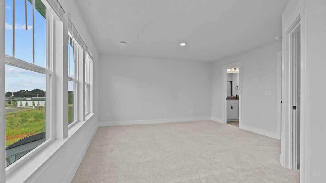 Vibrant natural light fills this exceptional primary suite with eye-catching details Vibrant natural light fills this exceptional primary suite with eye-catching details