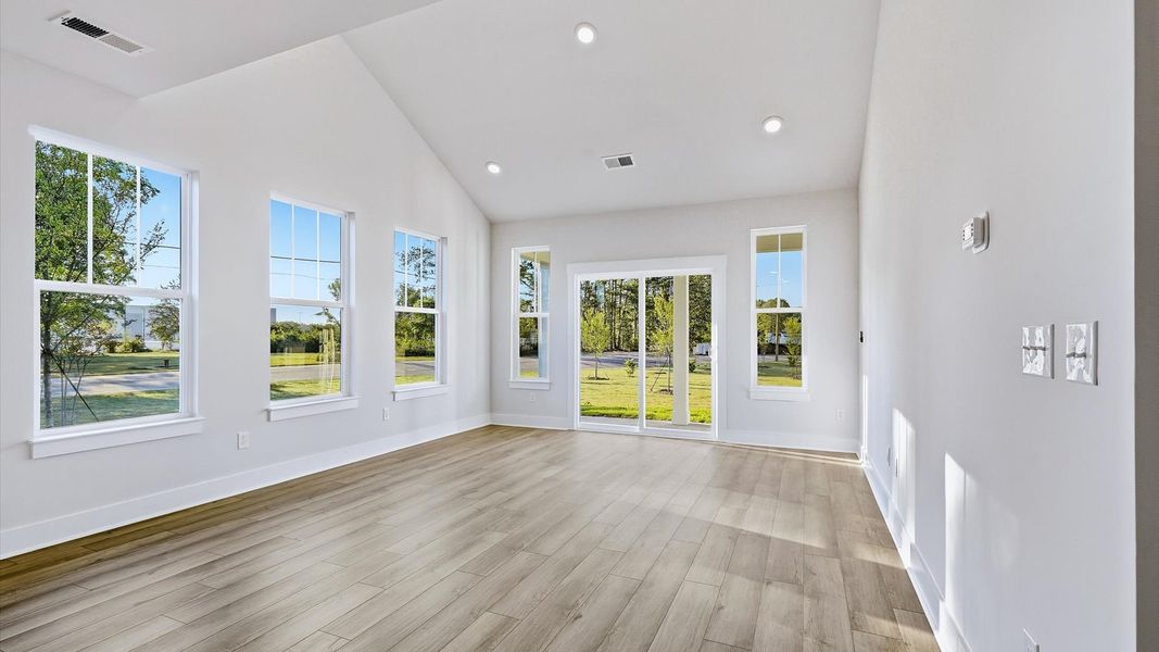 Spacious family room with rich hardwood flooring and elegant trim work in a reputable DRB Homes build Spacious family room with rich hardwood flooring and elegant trim work in a reputable DRB Homes build