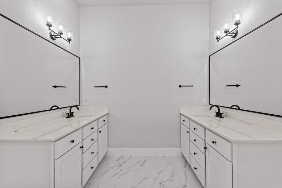 A bathroom with white cabinets.
