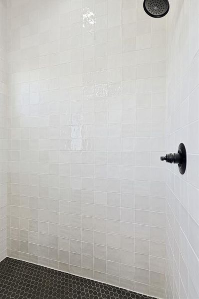 Primary bathroom details with a tile shower