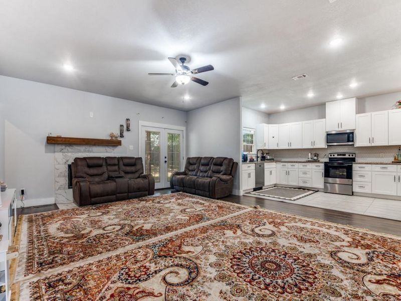 Living area with light wood-style floors, french doors, recessed lighting, and ceiling fan Living area with light wood-style floors, french doors, recessed lighting, and ceiling fan