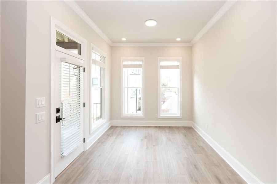 Light and bright Sunroom off Family room that opens to private back deck. Foyer with crown molding and light hardwood / wood-style flooring