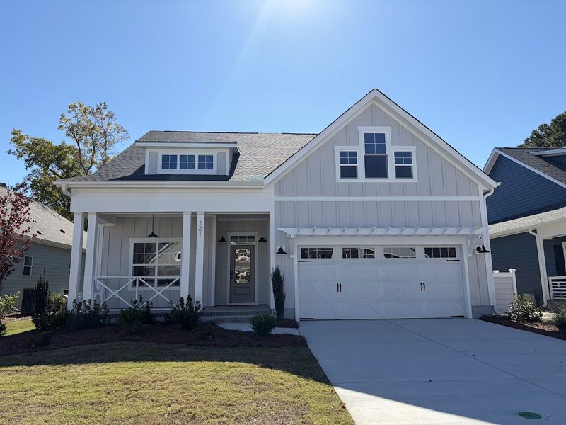 Front exterior of a new home in Riverside Cove, Wilmington, NC, highlighting curb appeal (Image 1).