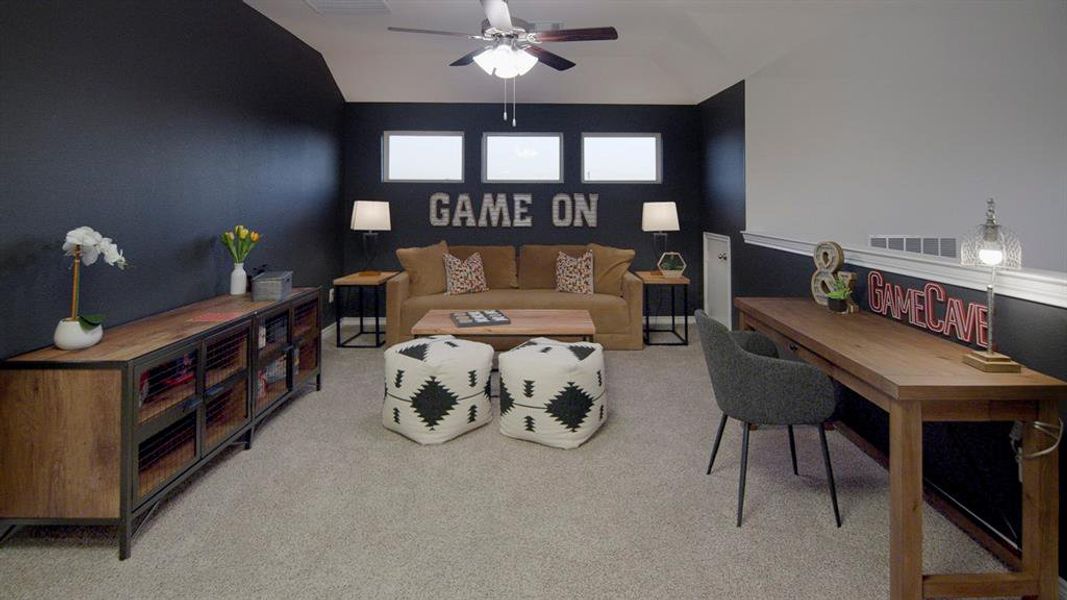 Expansive bonus room featuring textured carpeting and a ceiling fan Expansive bonus room featuring textured carpeting and a ceiling fan
