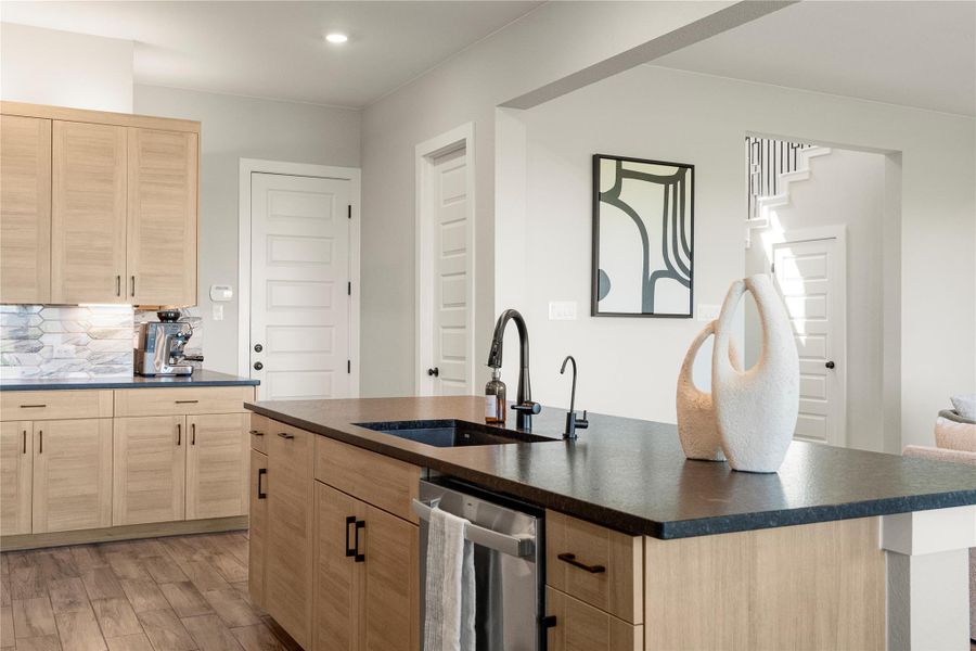 A well-appointed kitchen showcasing elegant wooden cabinetry, rich countertops, and durable wood flooring. A well-appointed kitchen showcasing elegant wooden cabinetry, rich countertops, and durable wood flooring.