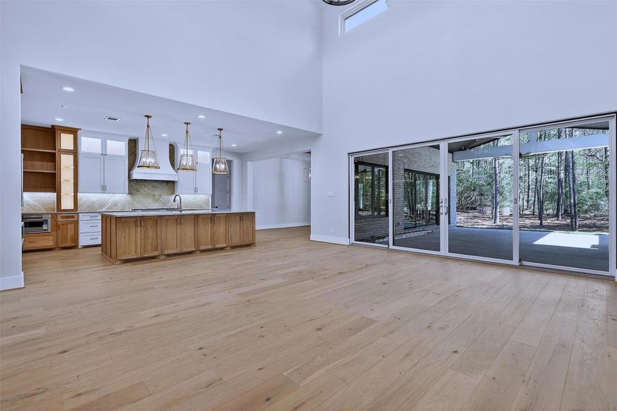 Natural light floods the room, highlighting its open, airy layout.