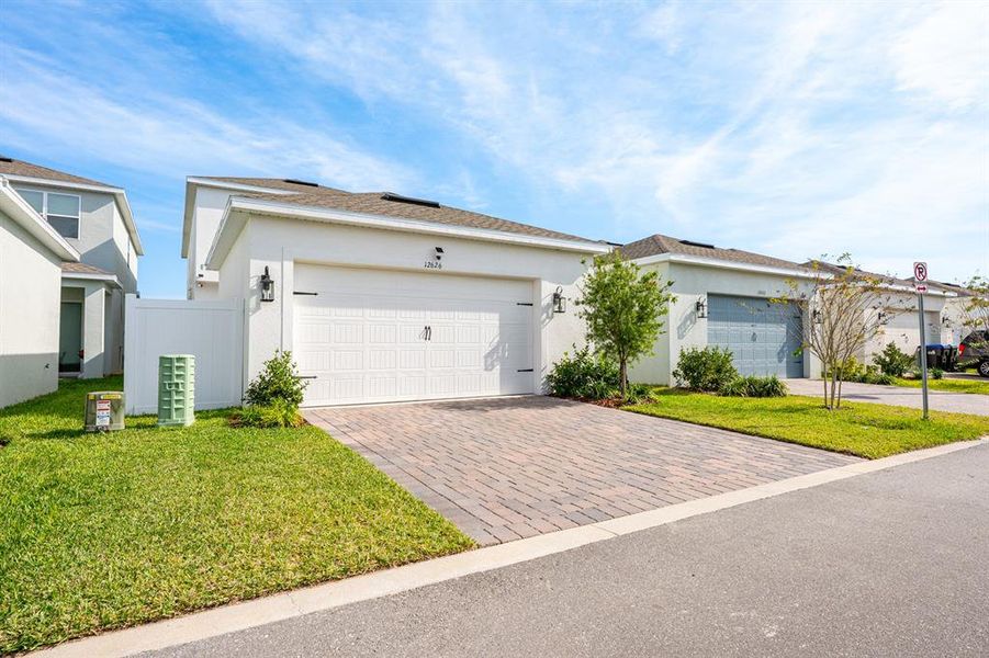 Front exterior of a new home in Osprey Ranch, Winter Garden, FL, highlighting curb appeal (Image 2). Front exterior of a new home in Osprey Ranch, Winter Garden, FL, highlighting curb appeal (Image 2).