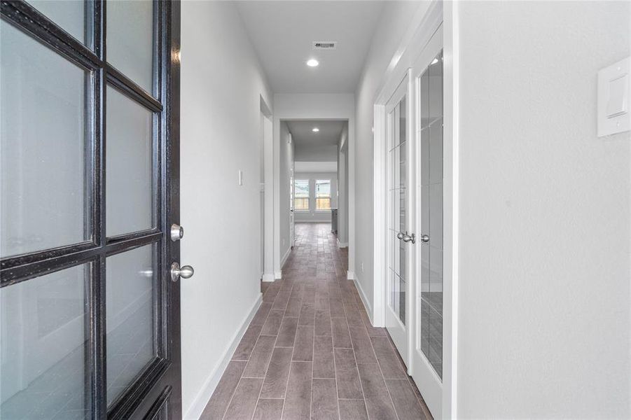 As you enter 2129 Reed Cave, you are greeted with the beautiful wood-like tile flooring, recessed lighting and custom paint.